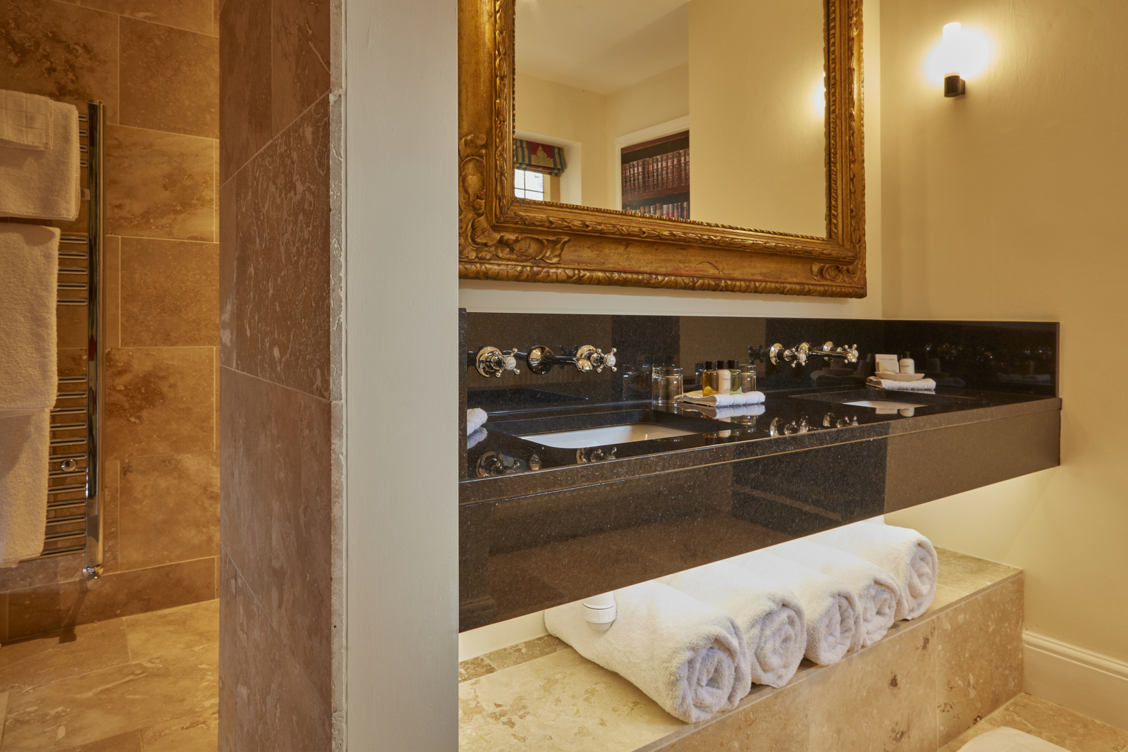 Elegant bathroom with towel set and beautiful mirror.