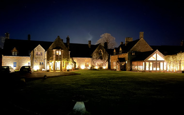 Illuminated at night the Abbots Grange frontage. 